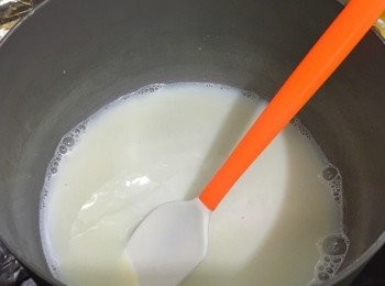 step2: 將鮮奶倒入煲裡用慢火煮熱，加入10g砂糖煮溶之後再加入雲尼拿香油伴勻