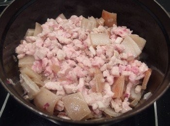 step8: 再加入切好的五花肉丁一起拌炒至上色,撒一些黑胡椒粉增加香氣。