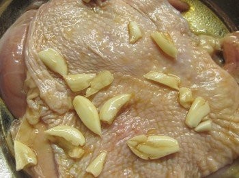 step3: 蒜頭拍碎放入作法2.並讓蒜頭都沾到<span class="group_2">醬汁</span>再均勻分佈在雞腿上