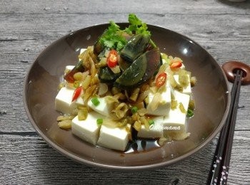 step4: 取出豆腐， 小心倒去水份， 放上榨菜粒及皮蛋件， 淋上醬汁， 灑上蔥花及辣椒粒便完成。