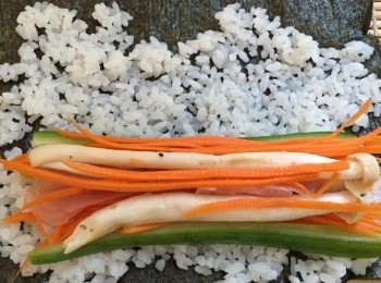 step3: 紫菜放在鍋上每邊烘 數秒，拿壽司席，放上紫菜(光身向下；啞色向上)，放上白飯盡量鋪平，然後放餡料，捲起壽司席用力壓實卷成長飯卷，