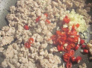 step3: 等待湯鍋水滾的同時來炒打拋肉. 炒鍋中不需加油放入絞肉炒到出油香味飄出,放入大蒜.辣椒末續炒,沿鍋嗆米酒去腥