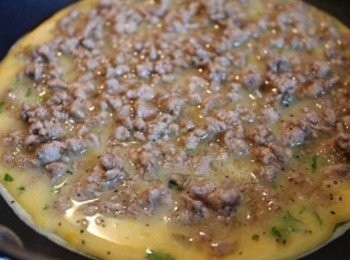 step3: 步取小煎鍋. 熱鍋少許油, 先下一半的<span class="group_2">蛋液</span>, 中火煎1分鐘後, 鋪上<span class="group_1">肉燥</span>