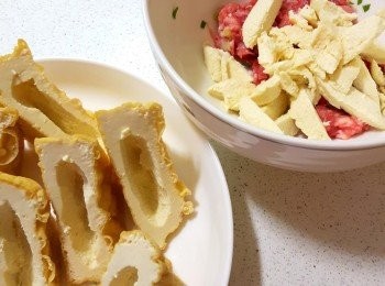 step2: 油豆腐4個對切，把裡面豆腐挖出來，放入絞肉裡。