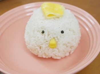 step9: 另外煎蛋皮稍微切成適當大小當頭上毛巾、

白飯捏成像是肉包形狀、海苔用打洞器壓出小圓形、

嘴巴用兩顆玉米插入中間即可、接著在旁邊淋上咖哩及雞腿即完成。