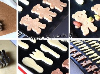 step11: 《可可麵糰》上用小熊餅乾模壓出小熊形狀
整齊地排列在烤盤上，拿一支烤肉竹籤
用竹籤粗的那端壓出小熊的眼睛
再用細的那端壓出小熊的鼻子
拿珍珠奶茶的胖吸管輕輕壓出小熊的肚子來
最後在小熊的雙手塗上一點蛋液
一手南瓜子；一手杏仁
馬上就讓餅乾豐富了起來~

《起司麵糰》則用小餐具餅乾壓模
同樣的方式壓出一些小匙、小叉、還有小刀子
這些小巧可愛的餐具餅乾深得弟弟的心
這小子居然只要餐具不要小熊了~