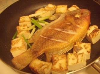step3: 然後魚煎第二面接近完成時擺入豆腐， 一樣煎至表面上色焦香，並加入蔥白一起爆香