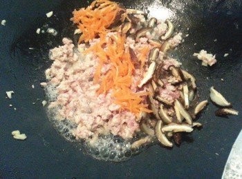 step2: 取一鍋將蒜末爆香加入絞肉翻炒數下再加入紅蘿蔔和香菇翻炒