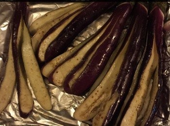 step3: 準備烤爐預熱至210C。
首先將烤盆用少許油塗抹上，以防會沾著茄子，然後將茄子排好在烤盆內，用小刷子塗抹上欖橄油，撒上蒜蓉，放入烤爐內烤約20分鐘，直至茄子熟。
