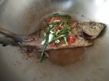 step3: 依序放入少許水、醬油，大約再續煎約10-15分鐘，看黃雞魚【澎湖野生水產】有沒有熟，若黃雞魚【澎湖野生水產】已熟，再放入青蔥、辣椒再悶鍋蓋約3分鐘後，