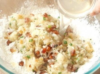 step8: 把鍋中的材料倒入粘米粉和粟粉中，加入浸蝦米的水拌勻成會黏手的麵團，待涼後，在手上沾少許油，把麵團平均分成12份，搓圓備用。