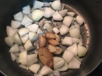 step7: 大湯鍋裡，放少許油，牛油猶佳，炒香洋蔥和湯底裡的薑和蒜頭。