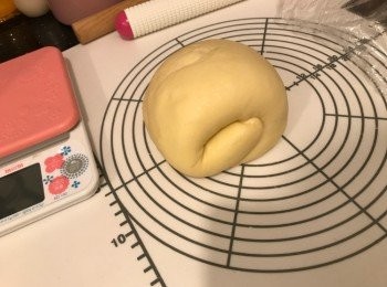 step3: 枱上灑上高筋麵粉，將第一次發酵完成的麵團空氣拍出，用木棍擀成長方形，先將1/3麵團摺上，再將1/3麵團摺下，捲起，包上保鮮紙，靜置10分鐘