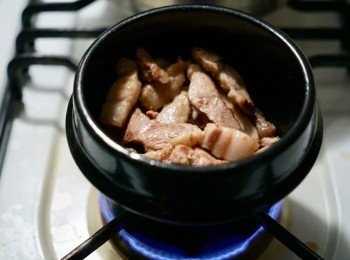 step2: 在一個用作燉煮的小鍋中，開中火，加一茶匙油，放下豬腩片，略炒直至熟透