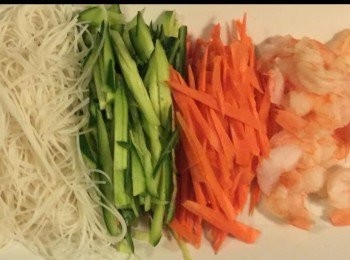 step2: 然後放一些蝦，蝦洗淨煮熟後，切開一邊。 米粉1束，放入滾水稍泡浸幾秒，直至轉軟在中央，適量米粉、青瓜、紅蘿蔔，九層塔、薄荷葉和生菜。