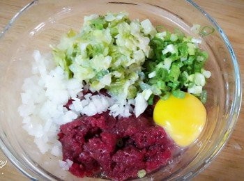 step2: 高麗菜洗淨切碎 , 用乾淨的碗放好 , 送入微波中約30秒 , 至軟後拿出來擠水 ; 洋蔥切碎 ; 蔥切蔥花 ; 牛肉片刴成泥狀 , 所有材料加入碗中 , 再加入蛋一個