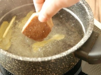 step2: 把薑片拍鬆後放進鍋中，加入水(糖水用)煮開後，加入片糖攪勻煮溶成糖水，盛起備用。