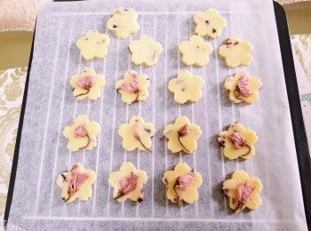 step7: 用櫻花形模壓出曲奇形狀，再放上鹽漬櫻花輕壓，放入已預熱160度之焗爐內，用160度焗10至12分鐘至金黃。