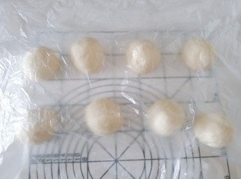 step6: 取出麵糰，排氣及翻麵，將麵糰分割成8份麵糰，然後滾圓。 蓋上保鮮紙，鬆弛15分鐘。