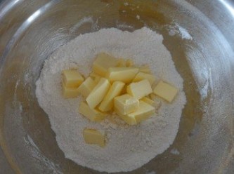 step1: 將麵粉、砂糖和泡打粉放入大碗內，拌勻。然後加入切小塊的牛油(牛油要用剛從雪櫃拿出來的）用手將牛油搓碎，與麵粉拌勻成夥粒狀