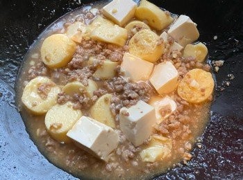 step4: 倒入玉子豆腐及絹豆腐，加入蠔油及水，炒一會後加蓋焗至汁料收杰即可。