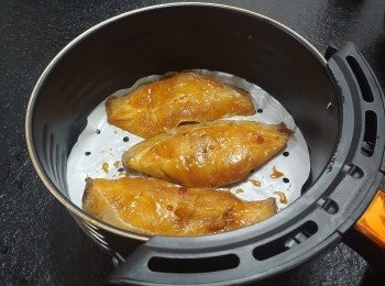 step5: 氣炸鍋舖上牛油紙， 放上比目魚; 在魚上噴小薄油