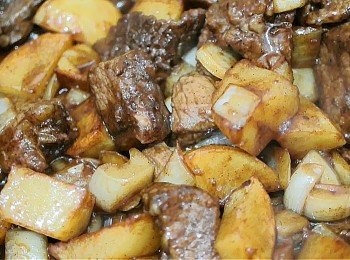 step6: 洋蔥變色後加入薯仔, 牛肉和醬汁, 用中大火煮至收汁為止, 加入蔥粒, 如喜歡重黑椒味可在這時加些現磨黑胡椒碎, 兜2下後熄火