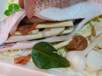 step2: 先放椰菜絲在BRUNO 鍋中，再放入烏頭魚，並在魚肚內塞入少許南薑，酸梅和香茅等。