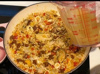 step9: 煮滾<span class="group_3">鮮魚海鮮高湯</span>，先倒入100ml高湯，攪拌後小火煮至湯汁吸收，攤平