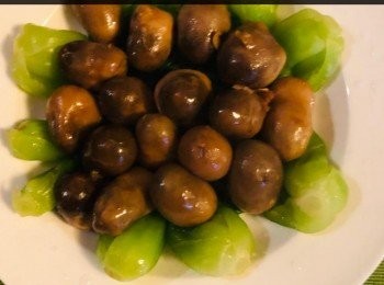 step5: 熱鑊下油，將少許蒜蓉炒一炒倒入草菇煮熟取出，鋪於小棠菜上備用。