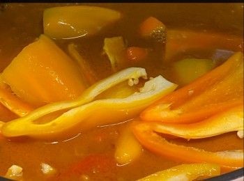 step10: 原鍋，小火將洋蔥炒軟，加入餘下醃料及黃糖炒勻，下西班牙香腸及蒜蓉，灑上白蘭地（Brandy），加入清雞湯、罐頭蕃茄及粗粒花生醬拌勻中火煮滾，下雞件，蓋上鍋蓋，轉小火煮30分鐘，熄火；不要打開鍋蓋，焗30 - 45分鐘左右（喜愛雞件淋身就焗45分鐘）。