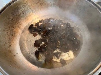 step4: 煮沸約500毫升水，加入大蒜碎、麻油和雲耳，先煮2分鐘。