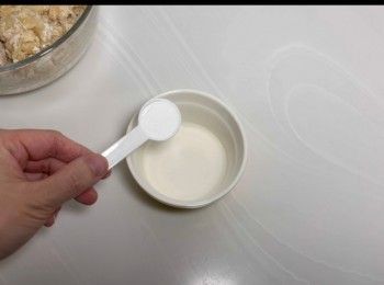 step6: 另外取出一個小碗，加入清水一湯匙、泡打粉一茶匙和臭粉半茶匙，拌勻。
