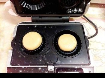 step2: 預熱電烤爐（待紅燈亮起計，至綠燈同時亮起）2. 將粉團平均分成2份（50 g），搓圓再略為壓扁，然後放入<span class="group_1">撻皮</span>模具中，蓋上蓋子，將<span class="group_1">撻皮</span>焗3.5-4分鐘至表面金黃，放涼，脫模，備用