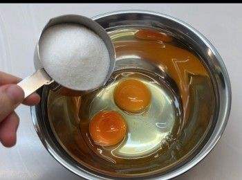 step1: 於容器內打入兩隻雞蛋，加入砂糖，攪拌至呈淡黃色。