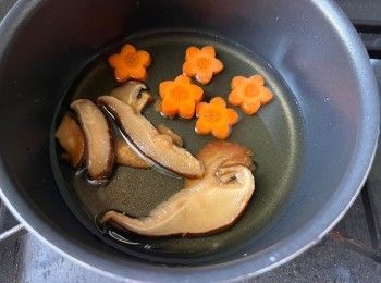 step2: 先用水浸泡香菇片至軟身，將浸泡香菇片和水連同香菇片以小火煮5分鐘至出味，再加入甘筍片多煮5分鐘，然後注入無糖豆漿煮沸。