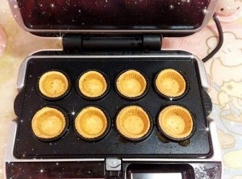 step6: 預熱電烤爐（待紅燈亮起計，至綠燈同時亮起） 2. 將粉團平均分成16份（10 g），搓圓，然後放入<span class="group_1">撻皮</span>模具中，蓋上蓋子，焗2-2.5分鐘至表面金黃，放涼，脫模，備用