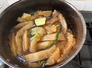 step9: 把擠乾水份的柚子皮放進鍋中稍炒，然後放進調味料、蝦皮碎和水，蓋上鍋蓋以小火慢煮10分鐘至汁收。