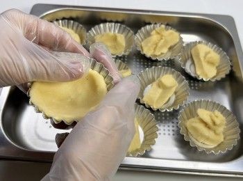 step9: 將雪凍的麵團分成每粒28克，壓在蛋撻模上。