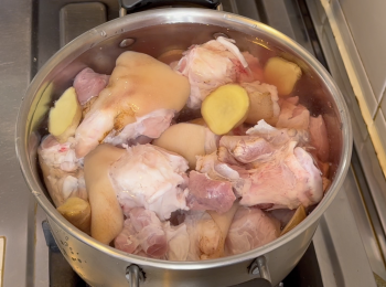 step3: 第2天，豬腳和豬手用水洗乾淨，豬腳和豬手汆水，薑和沼興酒加室溫水煮豬腳和豬手