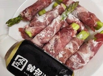 step3: 將蘆筍放在豚肉片，由下而上卷，豚肉末端輕輕鋪上粟粉收尾（以免開口）；再將全部捲好的豚肉卷，全部灑上適量黑胡椒，再每條裹上一層薄薄栗粉（備用）。