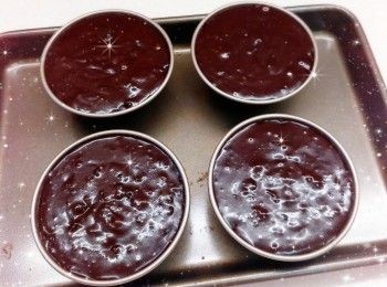 step4: 1. 粉漿加入蛋糕紙托中（8成滿），在桌面上敲幾下震出氣泡，然後在蛋糕表面放上適量朱古力粒