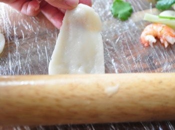 step3: 先在沾板上鋪上保鮮膜，塗上橄欖油，讓麻糬滑滑不沾黏，再用桿麵棍將分成一小小塊的麻糬桿成橢圓狀