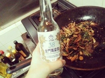 step2: 等熱鍋後放入麻油，放入薑片和蒜頭爆香並轉中小火，直到薑片和蒜頭有點乾的香氣出來，再放入小管干、丁香魚，（記得注意口感，別炒過硬，才易好咀嚼），並倒入少許【38度金門高粱酒】、少許醬油一起拌炒，接著放入辣椒再小炒一下，