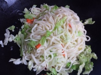 step2: 熱鑊放油炒烏冬一會，加入椰菜及紅蘿蔔拌勻