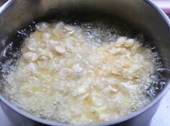 step6: 將適量的油品加熱後，放入沾好杏仁碎片的杏鮑菇片酥炸