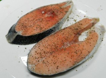 step1: 鮭魚又叫三文魚是家中常見的魚料理，料理方式多元。 鮭魚的熱量較一般魚類低，含有豐富的蛋白質、維他命A、D、B6、B12及多種礦物質含Omega-3不飽和脂肪酸高之魚類，是全家人營養的重要來源喔，小朋友吃了變聰明、大人吃了有體力、老人吃了加強腦力！ 先在鮭魚片上灑上黑胡椒粉與羅勒粉
