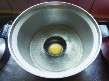step6: 溫泉蛋作法─在外鍋加入1/2 杯水煮到滾沸，將步驟1放入並蓋上鍋蓋煮1 分半～ 2 分鐘。接著再倒入蛋白煮1 分半鐘。