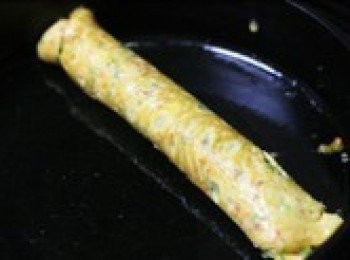 step7: 待第二層的雞蛋液表面也快變乾時，從第一層雞蛋捲這頭開始，把第二層雞蛋皮也給捲起來，如果分三次煎，就再煎第三層雞蛋液，最後捲成一大卷