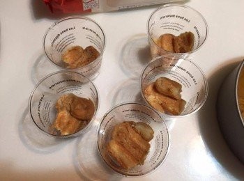 step6: 組合：將浸咖啡液的手指餅乾分成兩半，緊密排放在杯子的最下層，接著將起士糊一半均勻平舖在上方，同樣動作再放一層手指餅乾（盡量排的緊密），在最上層再舖上起士糊